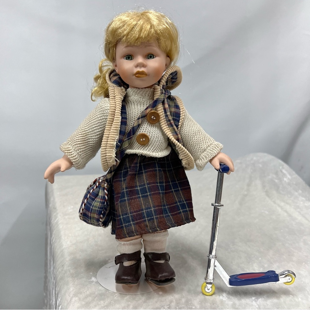 Porcelain vintage doll w/scooter 11 in. Blonde hair blue eyes plaid bag skirt